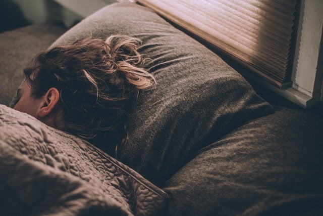 woman sleeping in bed with good sleep efficiency