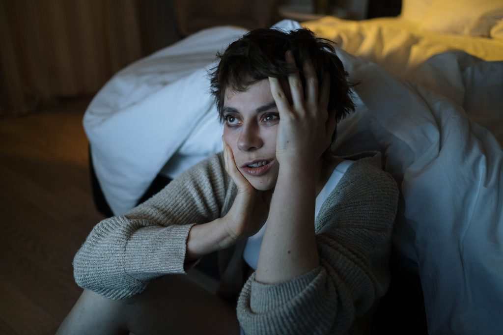 photograph of a woman touching her face