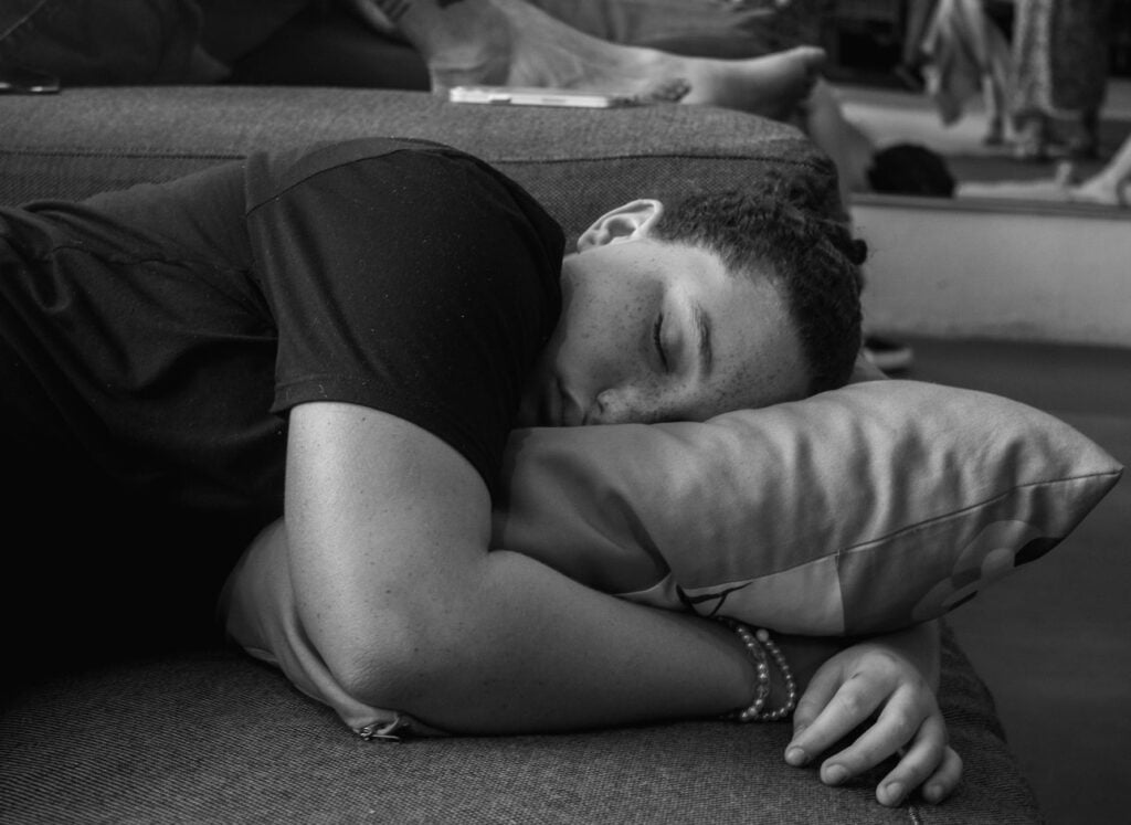 man sleeping on sofa after sleep paralysis