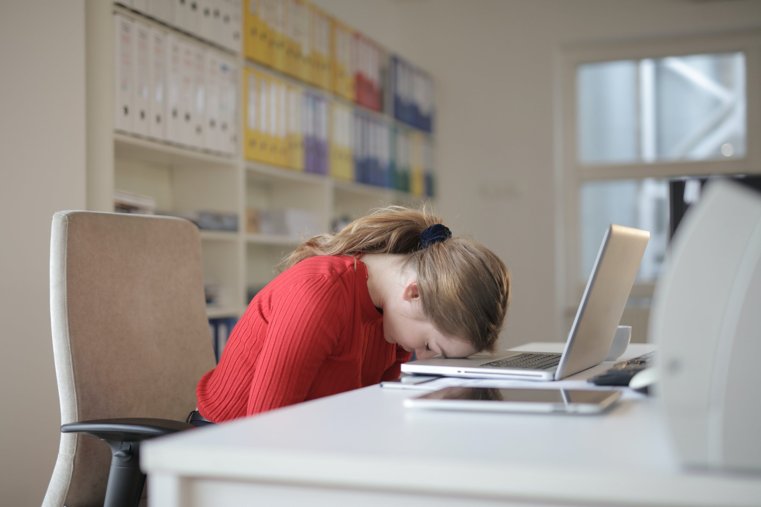 woman sleeping on laptop after working night shift