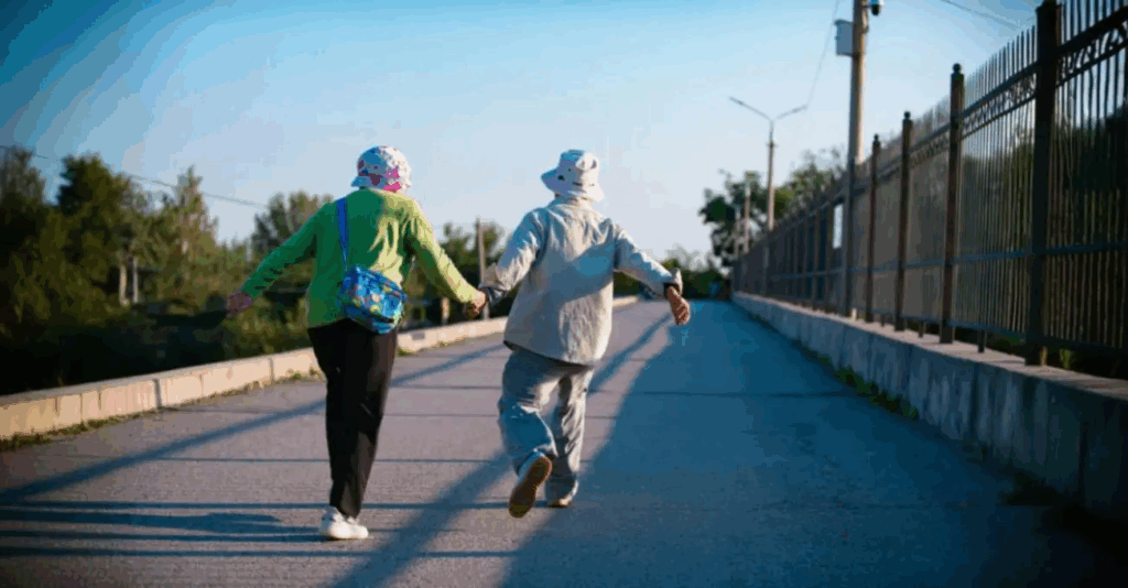aged woman and man running and exercising on a road