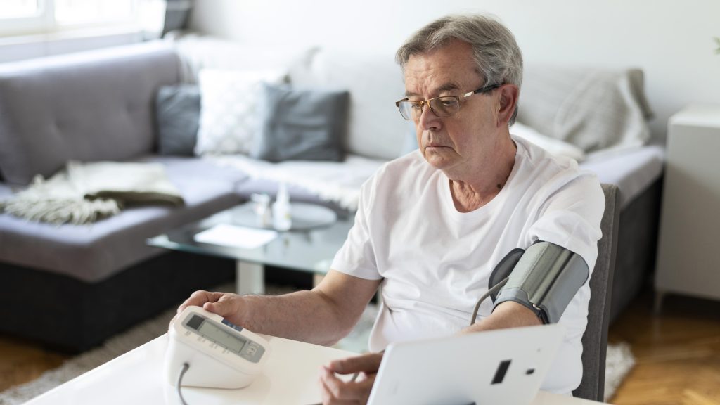 man with sleep apnea monitoring high blood pressure