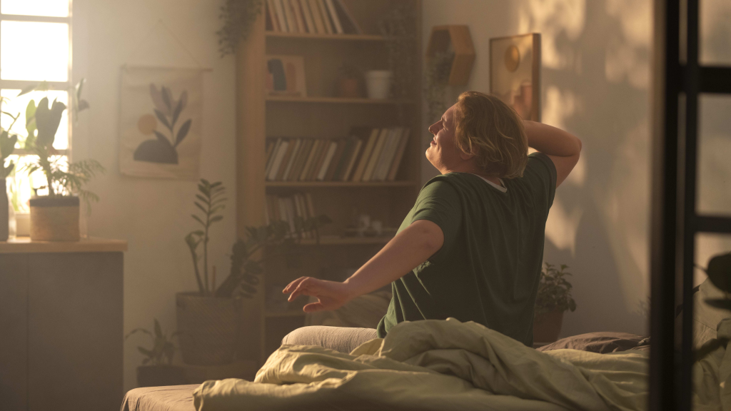 plus size person waking up and stretching in bed as part of act sleep therapy