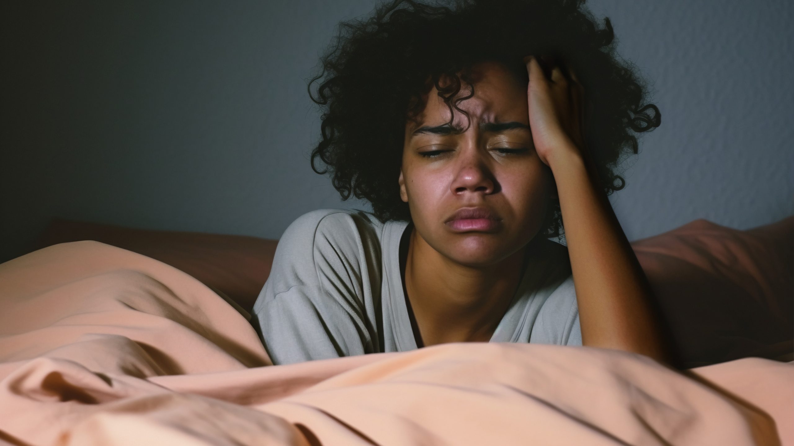 woman lying in bed experiencing an early morning awakening and feeling distressed