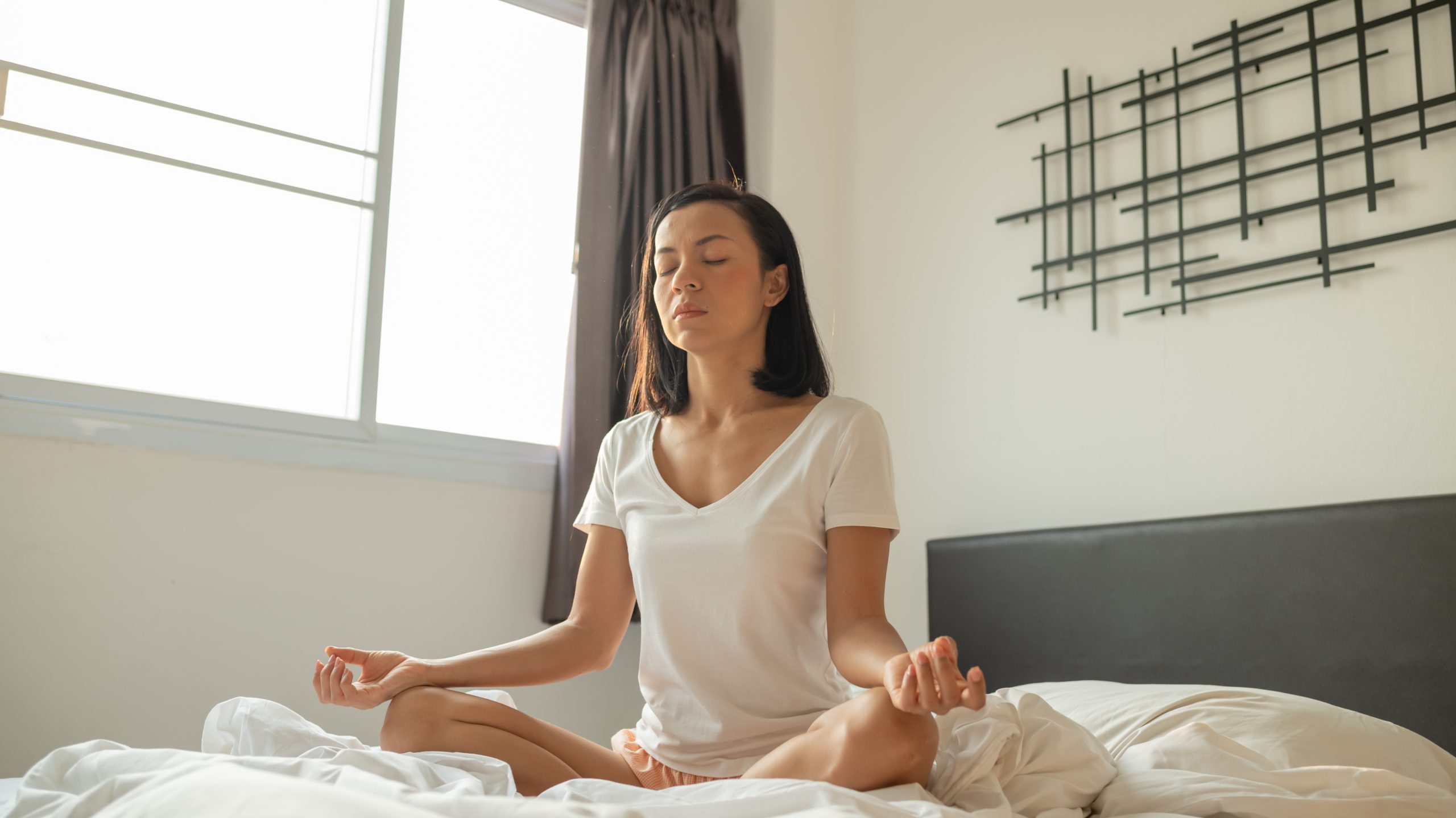 woman practicing meditation and breathing exercises for insomnia relief