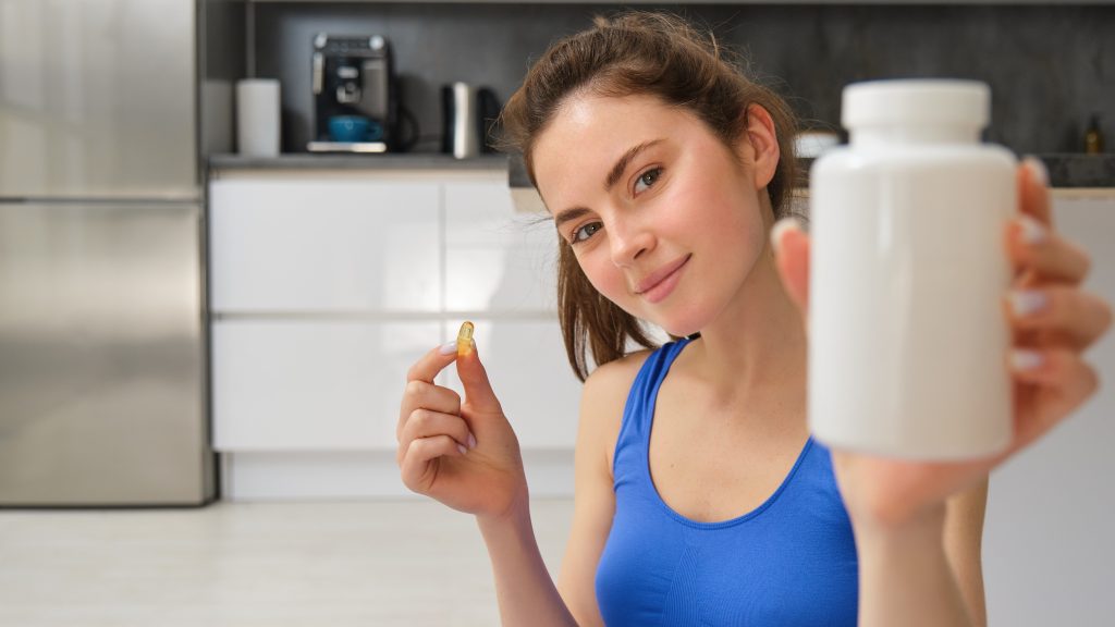 woman holding a melatonin supplement bottle as a sleep aid for insomnia