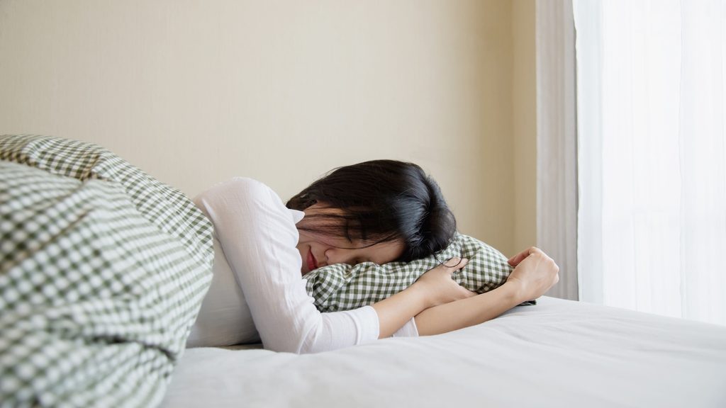 woman sleeping comfortably illustrating rest and insomnia relief for working moms